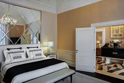 a bedroom with a bed and a chandelier at The St. Regis Rome in Rome