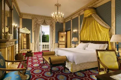 a bedroom with a large bed and a chandelier at The Westin Excelsior, Rome in Rome