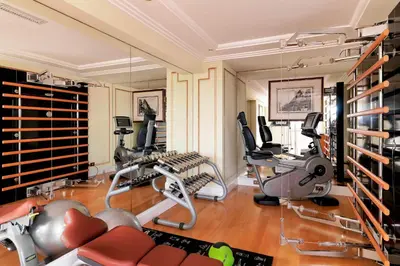 a gym with several exercise equipment in a room at The Westin Excelsior, Rome in Rome