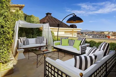 a patio with white couches and a table at The Westin Excelsior, Rome in Rome