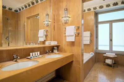 a bathroom with two sinks and a large mirror at The Westin Excelsior, Rome in Rome