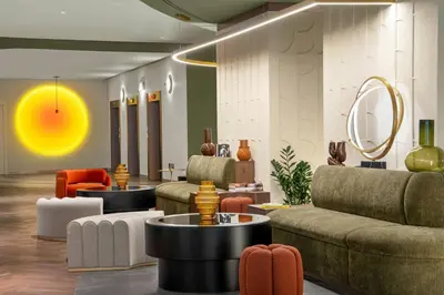 a lobby with couches and chairs and a table at Cardo Roma, Autograph Collection in Rome