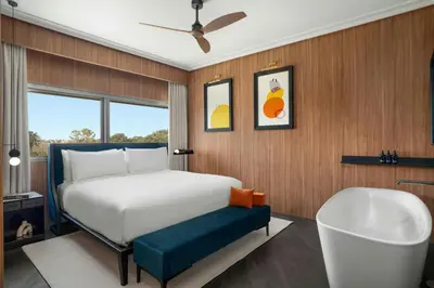 a bedroom with a bed and a bath tub at Cardo Roma, Autograph Collection in Rome