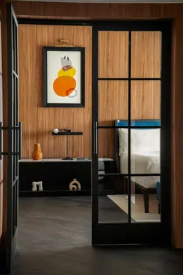 a bedroom with a bed and a glass door at Cardo Roma, Autograph Collection in Rome
