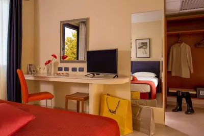 a bedroom with a desk with a computer and a bed at Best Western Blu Hotel Roma in Rome