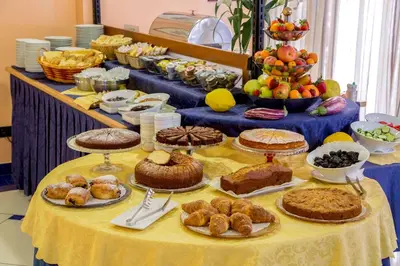 a table topped with lots of different types of food at Best Western Blu Hotel Roma in Rome