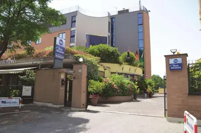 a building with a parking sign in front of it at Best Western Blu Hotel Roma in Rome