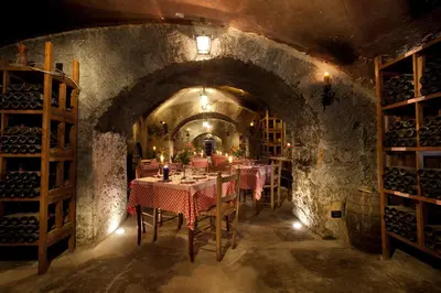 a dining room with tables and chairs in a wine cellar at Bettoja Hotel Massimo d'Azeglio in Rome