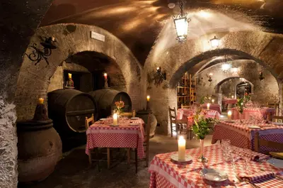 a room with tables and candles in a wine cellar at Bettoja Hotel Massimo d'Azeglio in Rome