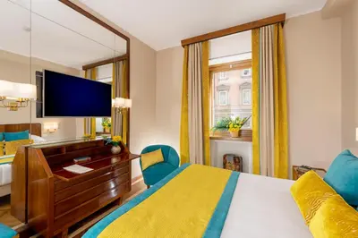a hotel room with a bed and a large mirror at Bettoja Hotel Mediterraneo in Rome