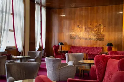 a waiting room with tables and chairs and a couch at Bettoja Hotel Mediterraneo in Rome