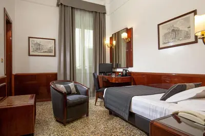 a hotel room with a bed and a desk at Hotel Nord Nuova Roma in Rome
