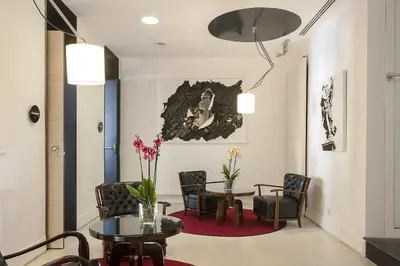 a waiting room with chairs and a table and a table and chairs at Hotel Nord Nuova Roma in Rome