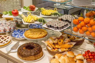 a buffet filled with lots of different types of food at Ludovisi Palace Hotel in Rome