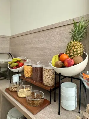 a table with a bowl of fruit and other food at Ludovisi Palace Hotel in Rome