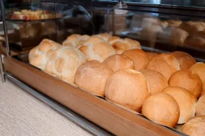 a display case filled with lots of loaves of bread at Ludovisi Palace Hotel in Rome