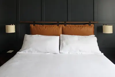 a bed with white sheets and two pillows at c-hotels Club House Roma in Rome