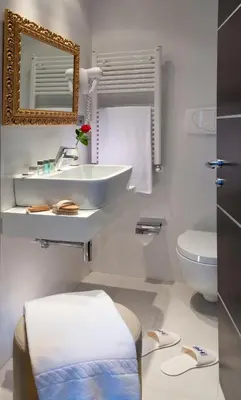 a white bathroom with a sink and a toilet at c-hotels Fiume in Rome