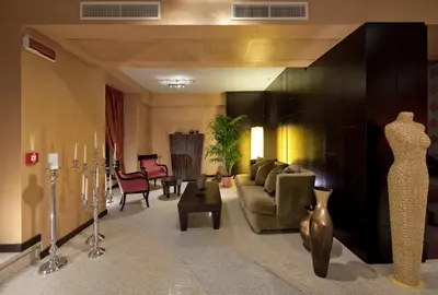 a living room with a couch and a table and chairs at c-hotels Fiume in Rome