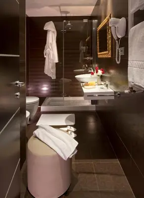 a bathroom with a sink and a toilet and a mirror at c-hotels Fiume in Rome