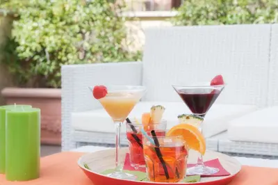 a plate with two cocktails and snacks on a table at Best Western Ars Hotel in Rome