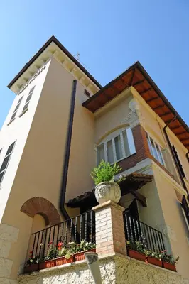 a building with a balcony with plants on it at Best Western Ars Hotel in Rome