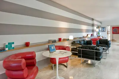 a waiting room with red chairs and a table at Best Western Ars Hotel in Rome