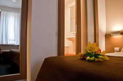 a bouquet of flowers on a bed in a hotel room at Hotel Concordia in Rome