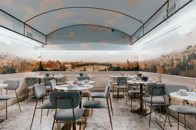 a restaurant with tables and chairs and a painting on the wall at Hotel Pantheon in Rome
