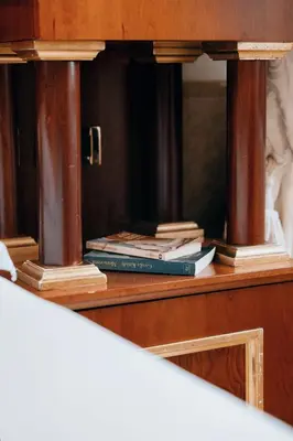 a stack of books sitting on top of a wooden cabinet at Hotel Pantheon in Rome