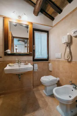 a bathroom with a sink and a toilet and a mirror at Hotel Pantheon in Rome