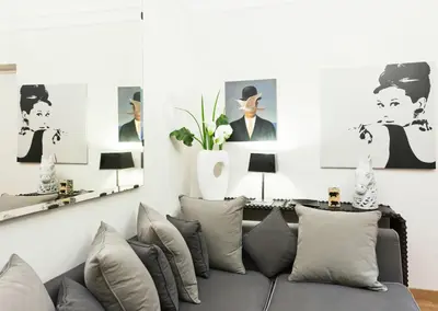 a living room with a couch and pictures on the wall at Casa Roma Luxury Apartment in Rome