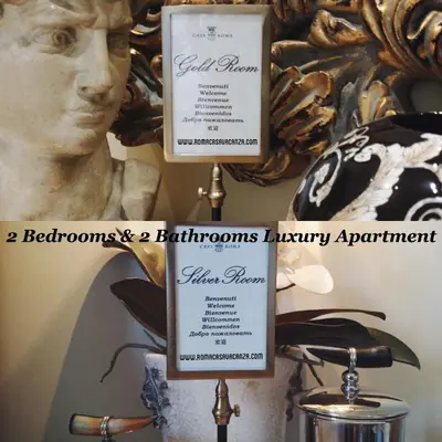 two informational signs in front of a statue at Casa Roma Luxury Apartment in Rome