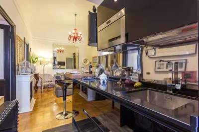 a kitchen with a large counter top in a room at Casa Roma Luxury Apartment in Rome