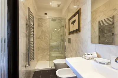 a bathroom with a shower and a toilet and a sink at Casa Roma Luxury Apartment in Rome