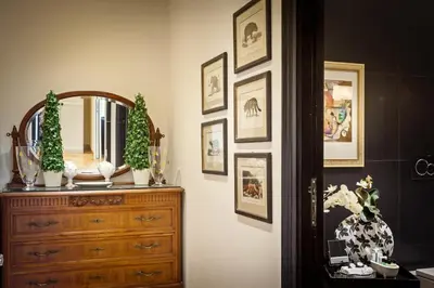 a room with a dresser and a mirror on a wall at Casa Roma Luxury Apartment in Rome