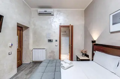 a bedroom with a white bed and a door at Hotel Family House in Rome