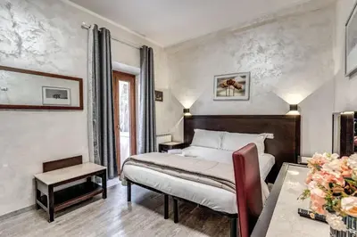 a hotel room with a bed and a table at Hotel Family House in Rome