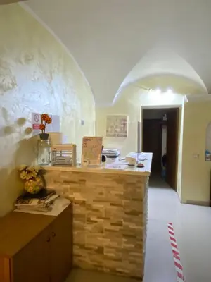 a kitchen with a counter in a room with an archway at Hotel Family House in Rome