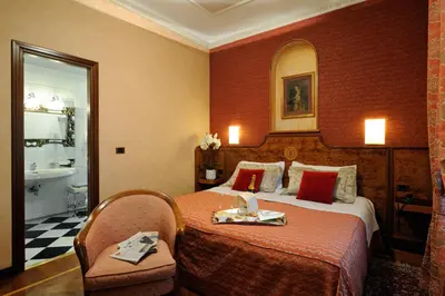 a hotel room with a bed and a bathroom at Hotel Farnese in Rome