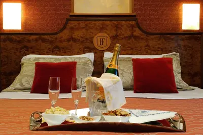 a table with a tray of food and a bottle of champagne at Hotel Farnese in Rome