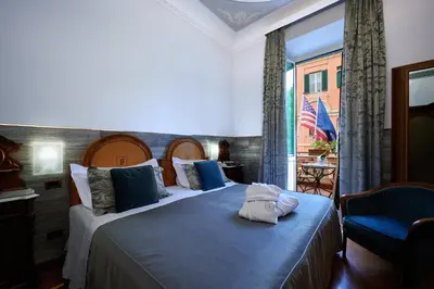 a hotel room with two beds and a window at Hotel Farnese in Rome