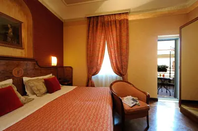 a hotel room with a bed and a window at Hotel Farnese in Rome