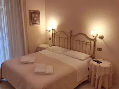 a bedroom with a large bed with two towels on it at Marta Guest House in Rome