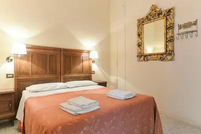 a bedroom with a bed with two towels on it at Marta Guest House in Rome