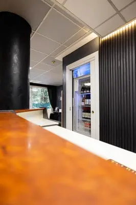 a kitchen with a table and a refrigerator at Scheppers Hotel in Rome