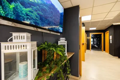 a large tv on a wall in a hallway at Scheppers Hotel in Rome