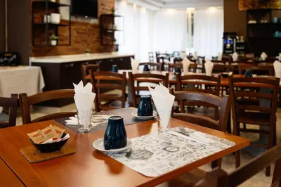 a dining room with a wooden table and chairs at Scheppers Hotel in Rome