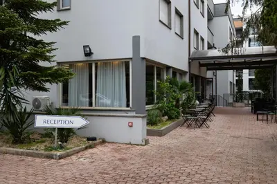a white building with a sign that says repetition at Scheppers Hotel in Rome