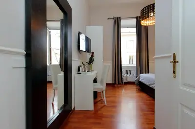 a room with a mirror and a table and a bed at 4BNB - Otranto Vatican Apartment in Rome
